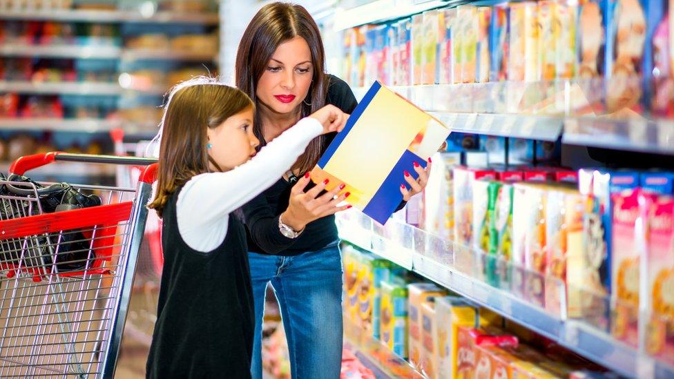 Mum and daughter shopping for cereals