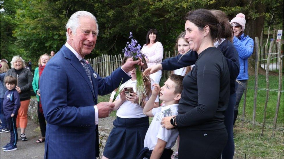 Prince Charles receives some flowers during a visit to Slieve Gullion Forest Park