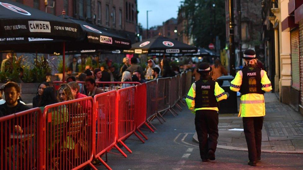 Police patrol near a bar in Manchester