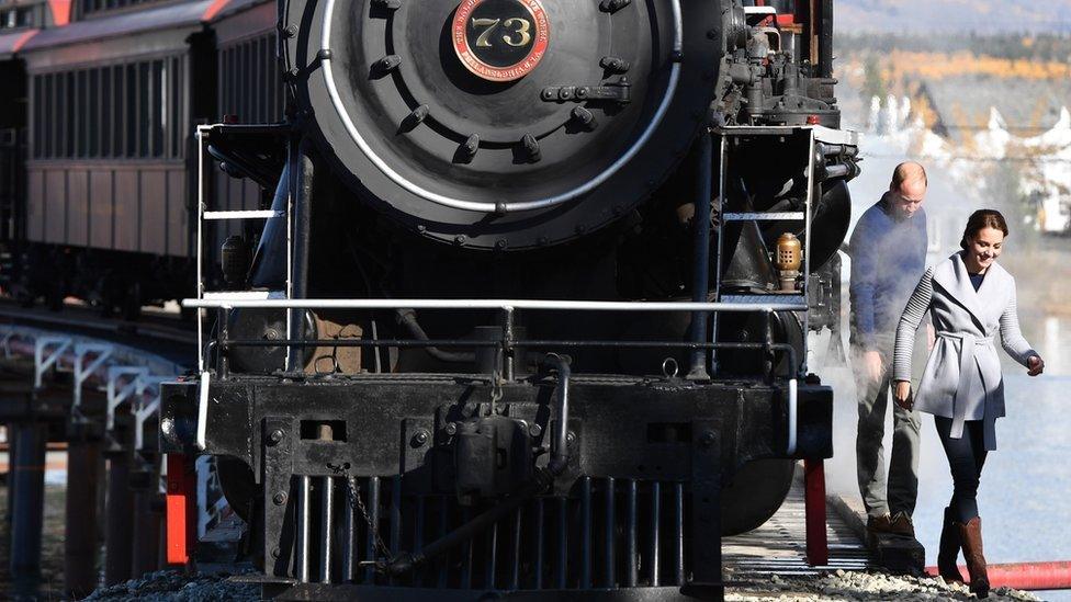 The Duke and Duchess of Cambridge walk beside a steam train in Carcross, Yukon