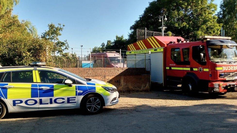 Fire engine and police car outside Grimsbury Reservoir