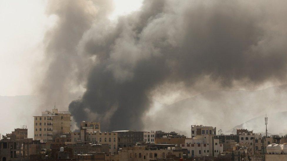 Smoke billows from the scene of Saudi-led coalition air strikes in Sanaa, Yemen (7 March 2021)