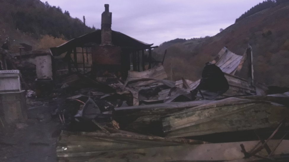 The charred remains of the house on Monday morning