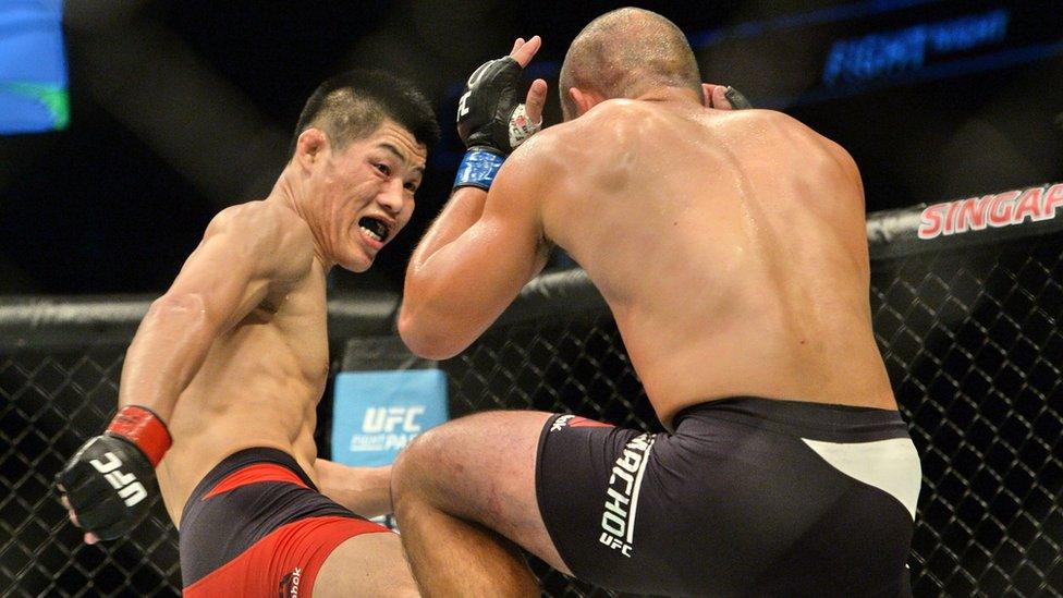 Li Jingliang of China competes against Frank Camacho of the Northern Mariana Island in the UFC Fight Night in Singapore