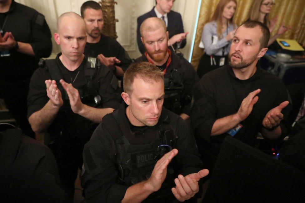 Members of the U.S. Secret Service Counter Assault Team applaud for one of their own