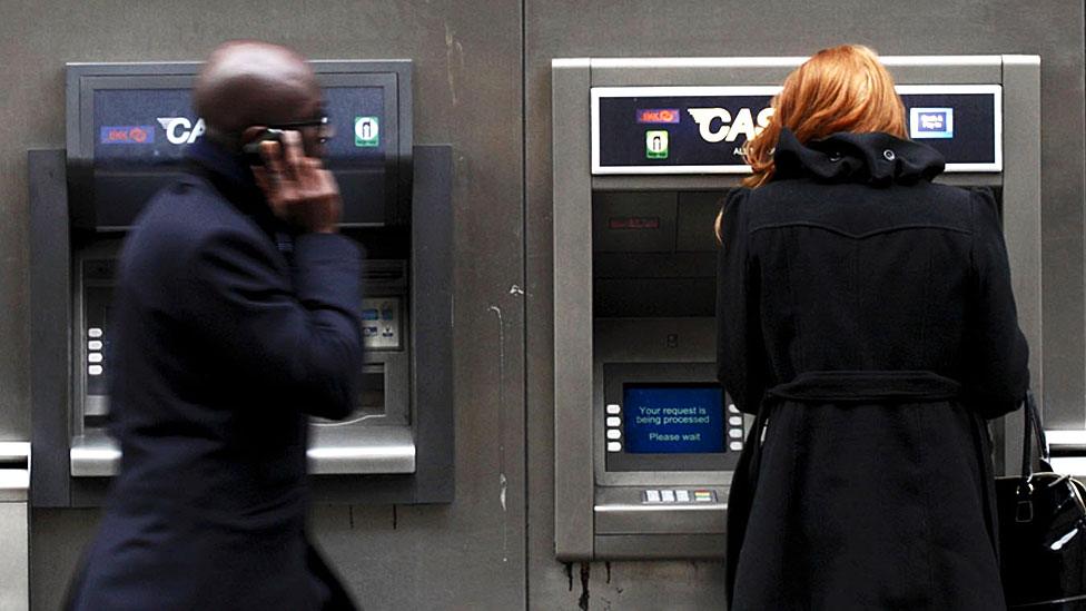 Man and woman at cashpoint