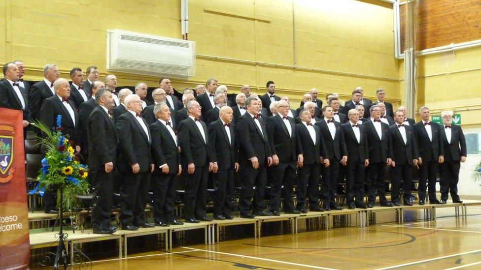 Caldicot Male Voice Choir standing together at a performance