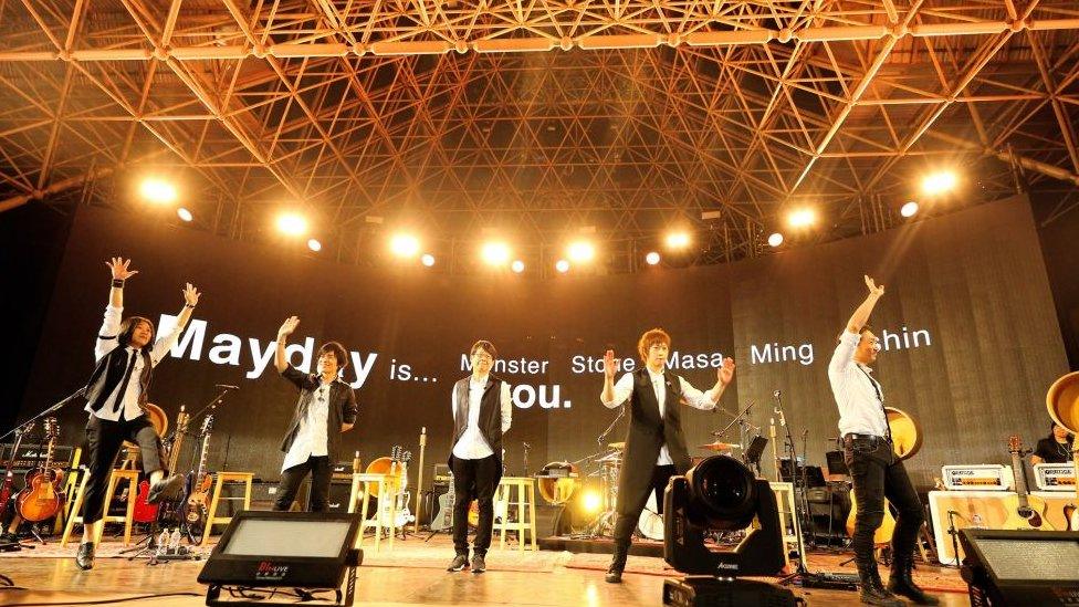 Members of rock band Mayday perform during their 20th anniversary concert at Daan Forest Park on March 29, 2017 in Taipei, Taiwan