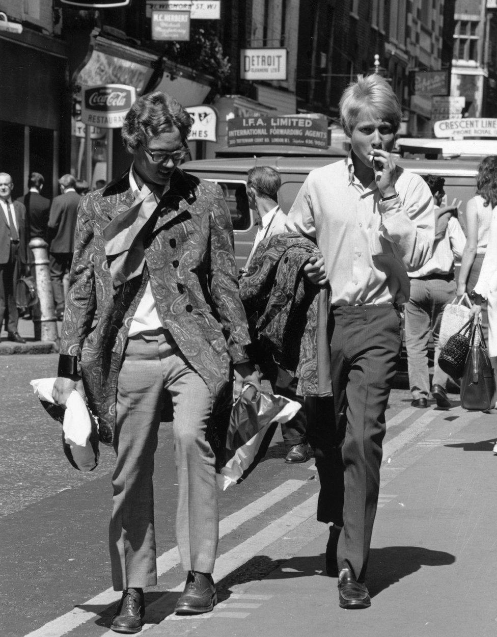 Two young men walk down London's Carnaby Street in 1967