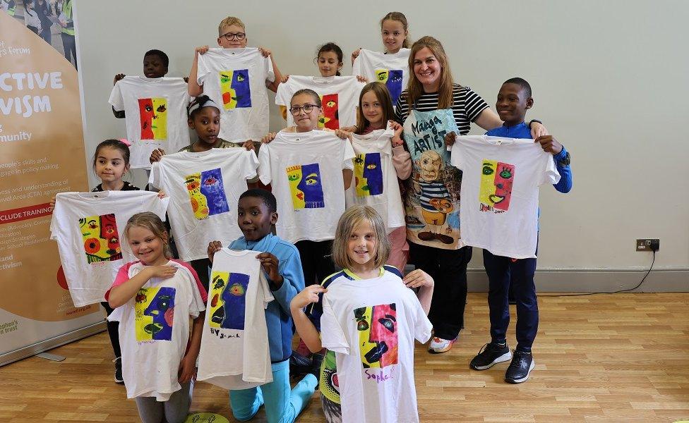 North West Migrants Forum summer scheme children holding tshirts