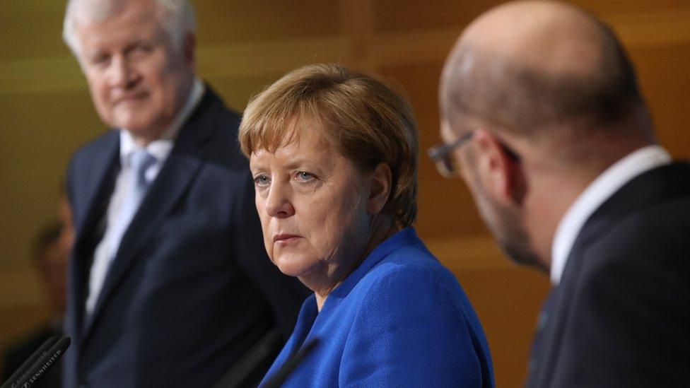 German Chancellor and CDU head Angela Merkel with leader of the Bavarian Christian Democrats (CSU) Horst Seehofer and leader of the German Social Democrats (SPD) Martin Schulz on January 12, 2018 in Berlin, Germany