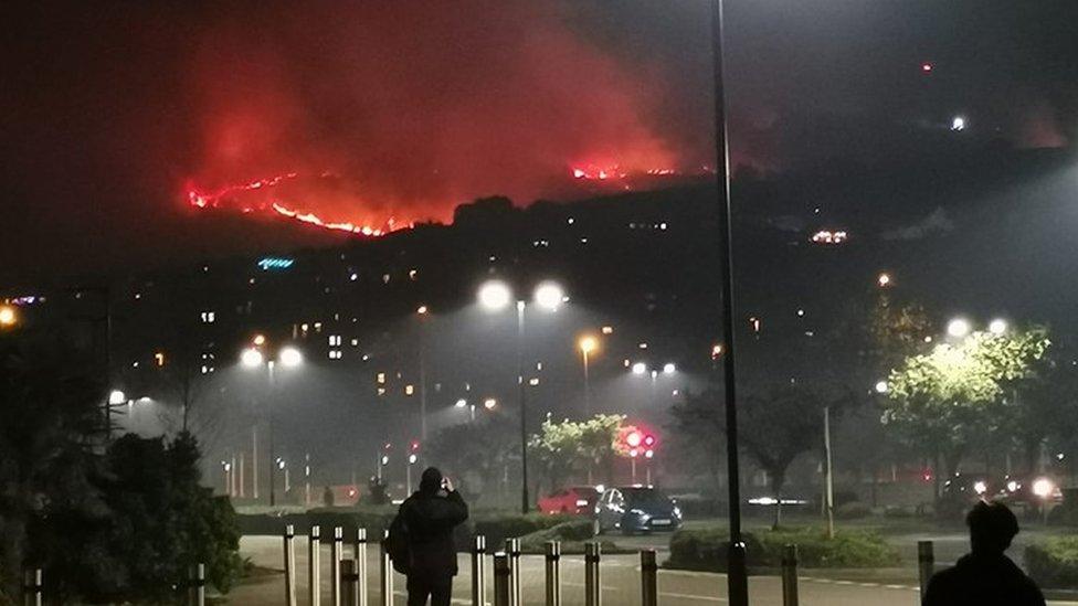 Onlookers watch fire on Kiley Hill