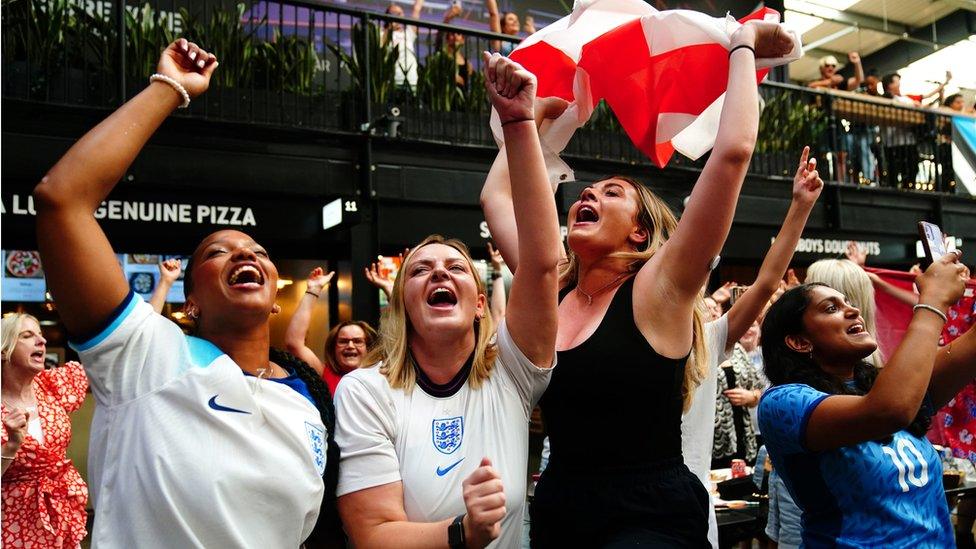 Three England fans celebrating