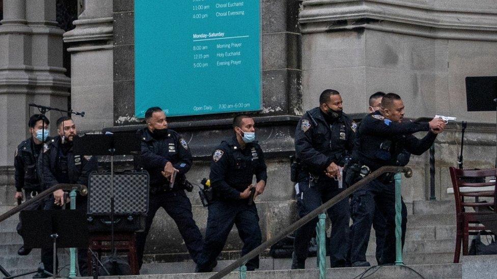 Officers move in on a gunman outside a cathedral in New York