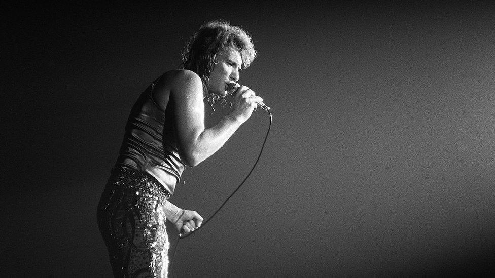 This file photo taken on September 28, 1971 shows French singer Johnny Hallyday performing on stage at the Palais des Sports