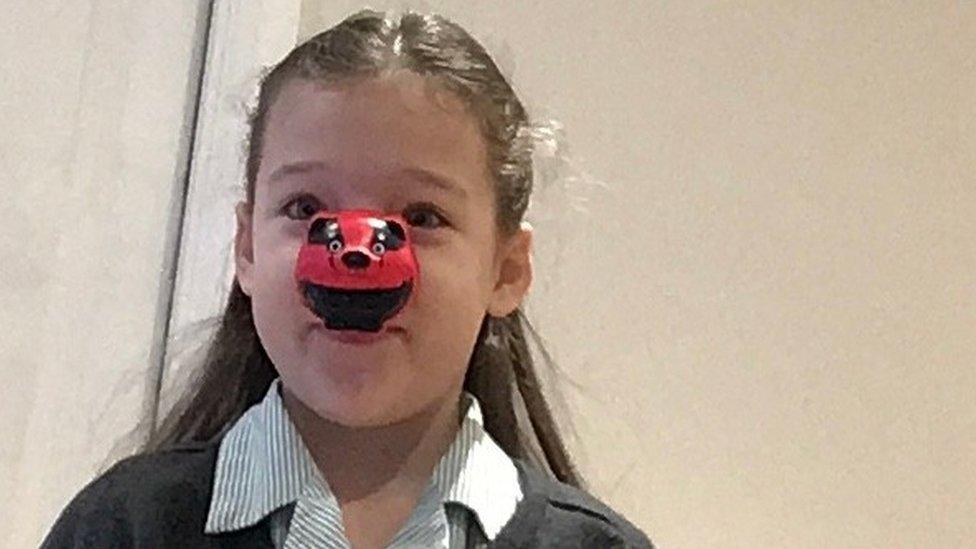 Girl wearing a red nose