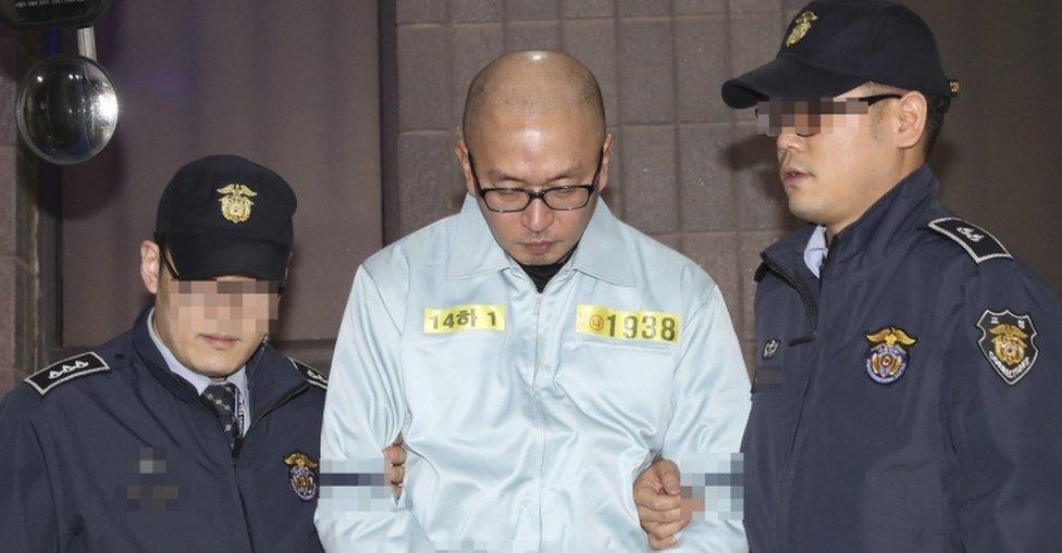 South Korean artistic director Cha Eun-taek, a key suspect in the influence-peddling scandal involving a close friend of South Korean President Park Geun-hye, is escorted after his arrest in Seoul, South Korea, on 12 November 2016.