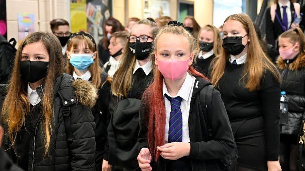 School corridor with secondary school pupils wearing masks