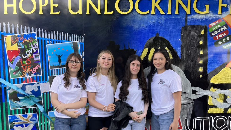 Young people at the mural near the gate at Northumberland Street