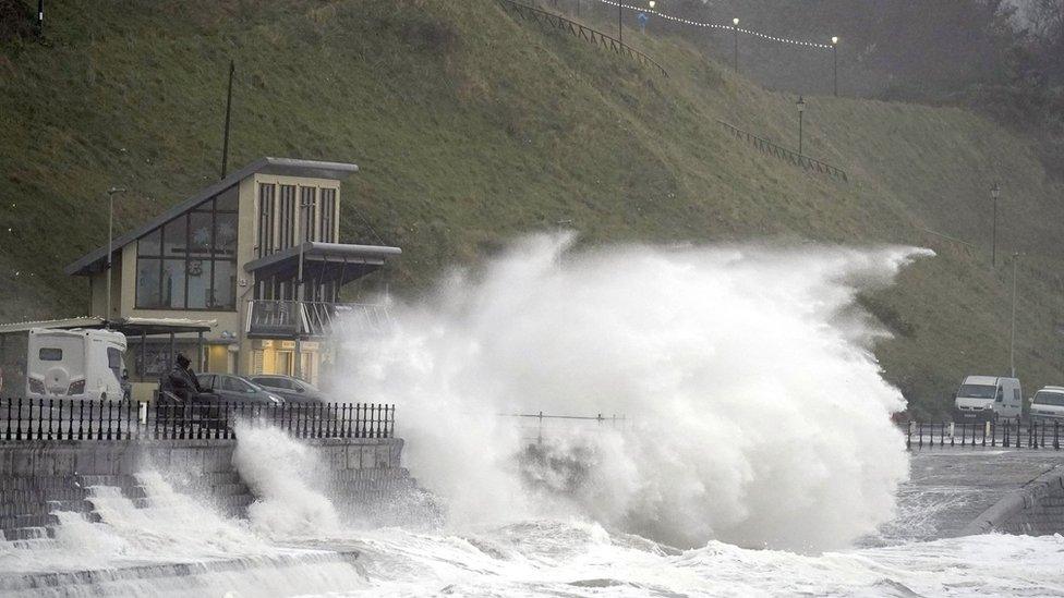 waves crashing over promenade in Scarborough