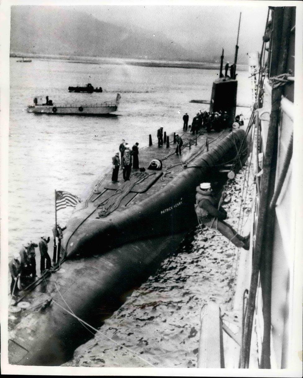 The 6700-ton American Polaris submarine ''Patrick Henry'' arrived in the Holy Loch, Firth of Clyde, today, and tied up alongside the submarine depot ship ''Porteus''