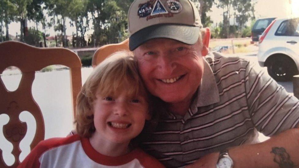 Image showing a young Louis Alexander hugging his grandfather Captain Rick Taylor