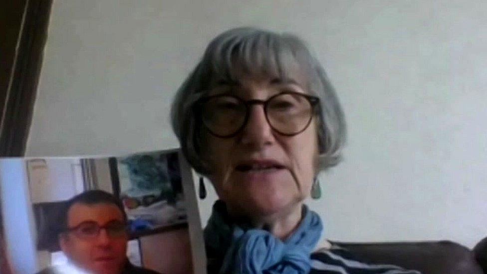 Louisa Spivack with a photo of her son, Daniel