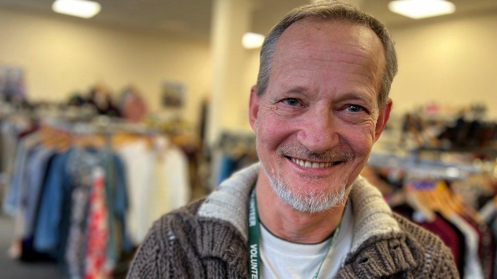 David from Clacton, standing in a charity shop.