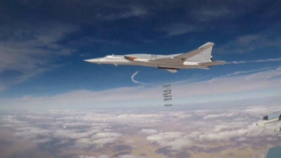 A still image from video handout shows a Russian long-range bomber hitting targets in Syria on 25 November