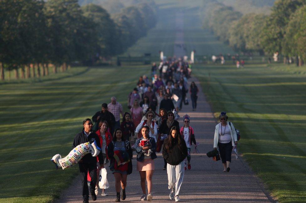 Well-wishers arrive on the Long Walk leading to Windsor Castle ahead of the wedding and carriage procession of Britain's Prince Harry and Meghan Markle in Windsor, on May 19, 2018