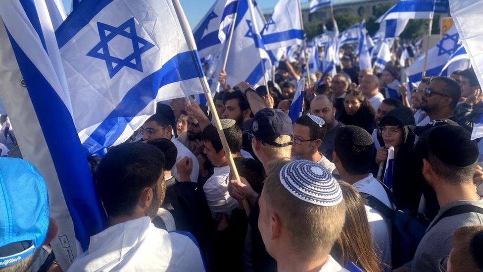 Right-wing nationalist Israelis take part in a flag march in Jerusalem on 20 April 2022