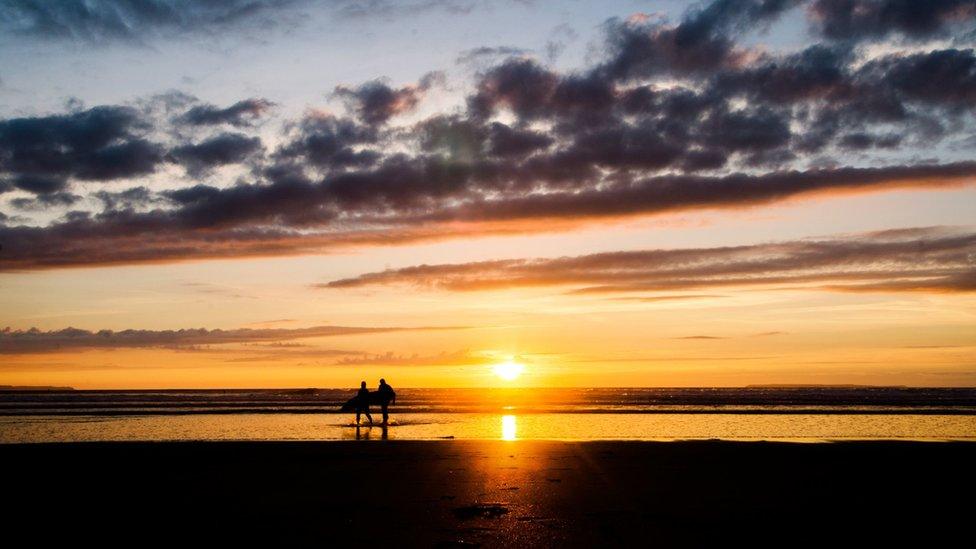 Surfers on a beach at Croyde Bay