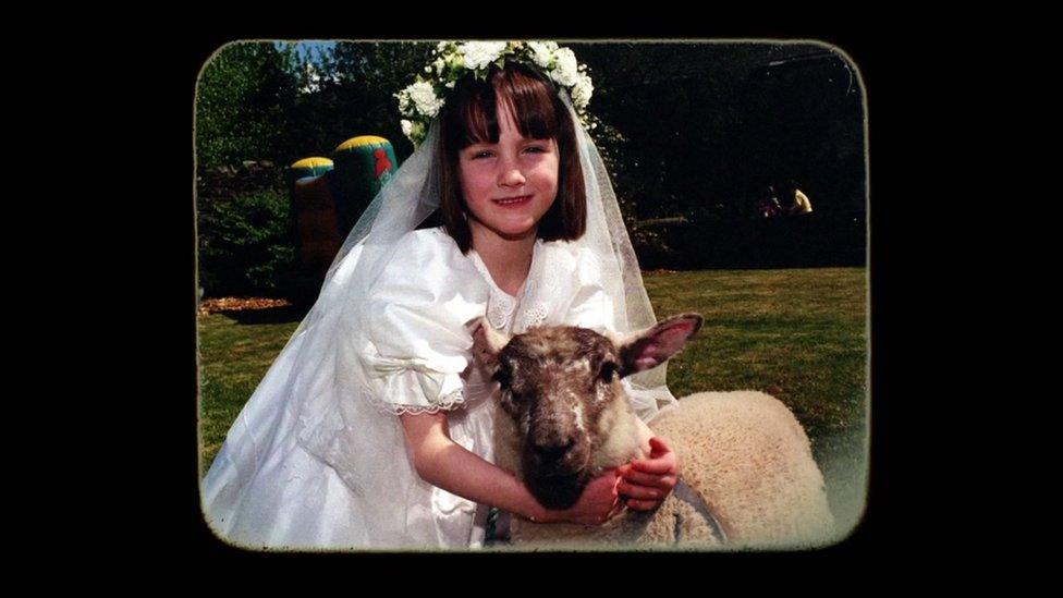 Rachael Blackmore with her pet lamb Joey as a child in her first holy communion dress.