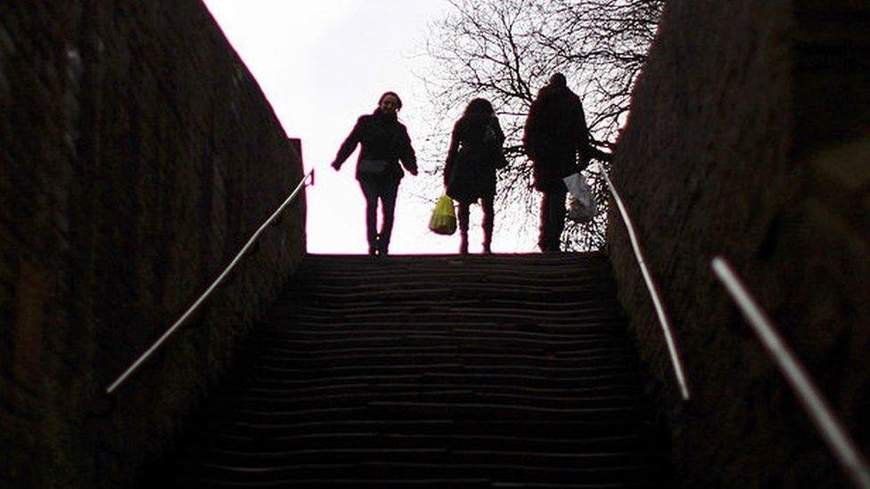 Three silhouetted figures - stock picture