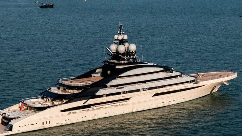 The Nord superyacht docked in Hong Kong waters with the city skyline in the background