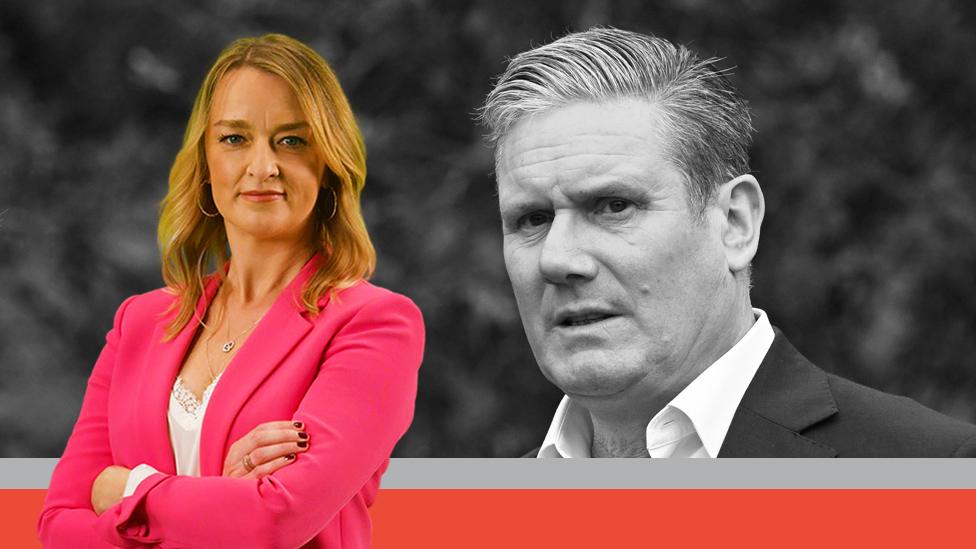 Laura Kuenssberg, wearing a pink blazer, stands in front of a black-and-white image of Keir Starmer