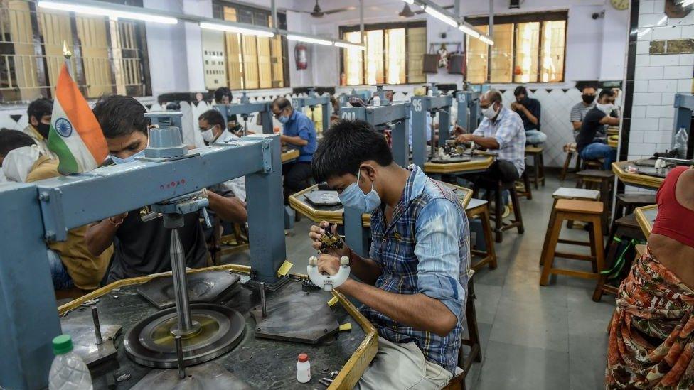 Workers examine diamond stones