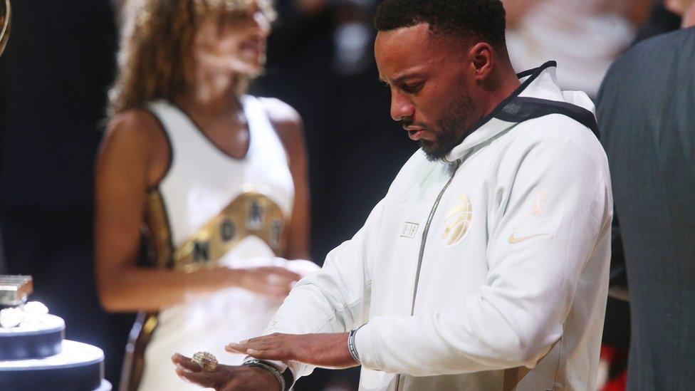 Toronto Raptors guard Norman Powell looks at his championship ring