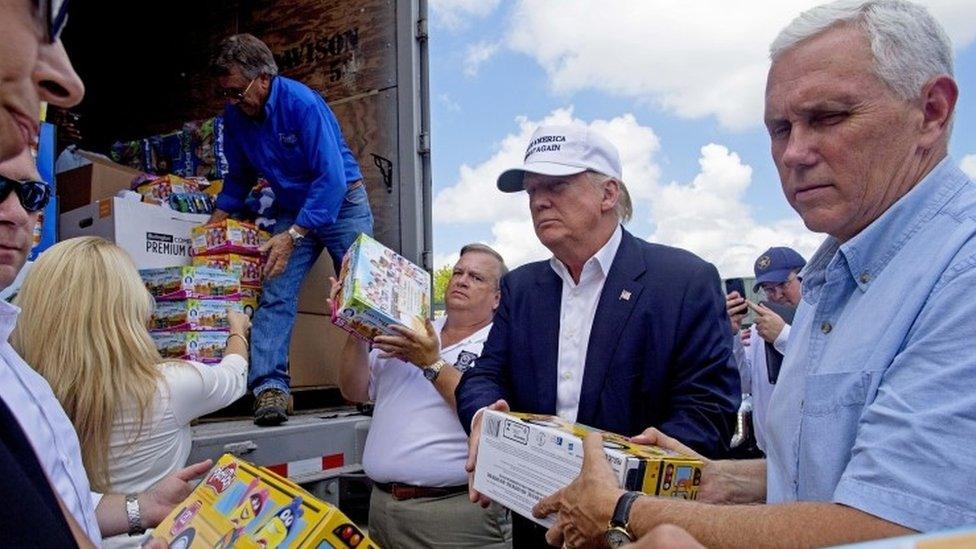 Republican presidential candidate Donald Trump and running mate, Indiana Gov. Mike Pence, unload donations for Louisiana flood victims.