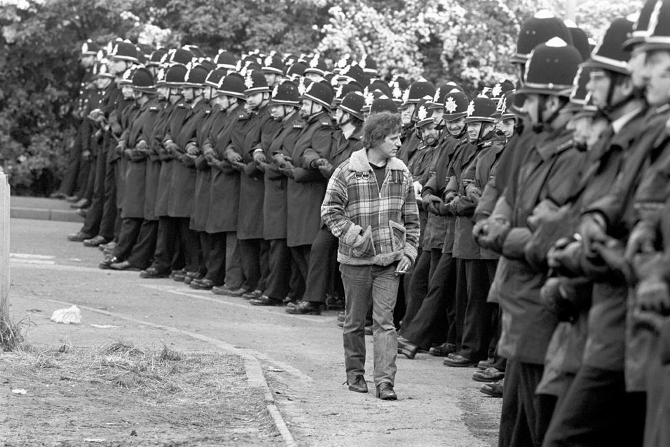 Miner strolls down police line