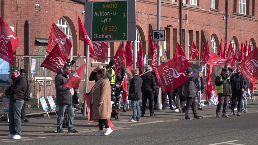 Strikers wave flags