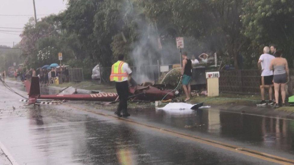 Residents used garden hoses to try to extinguish the blazing helicopter