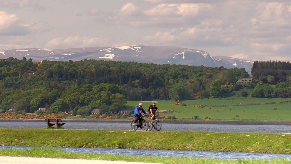 Cyclists alongside Loch Ness in Scotland