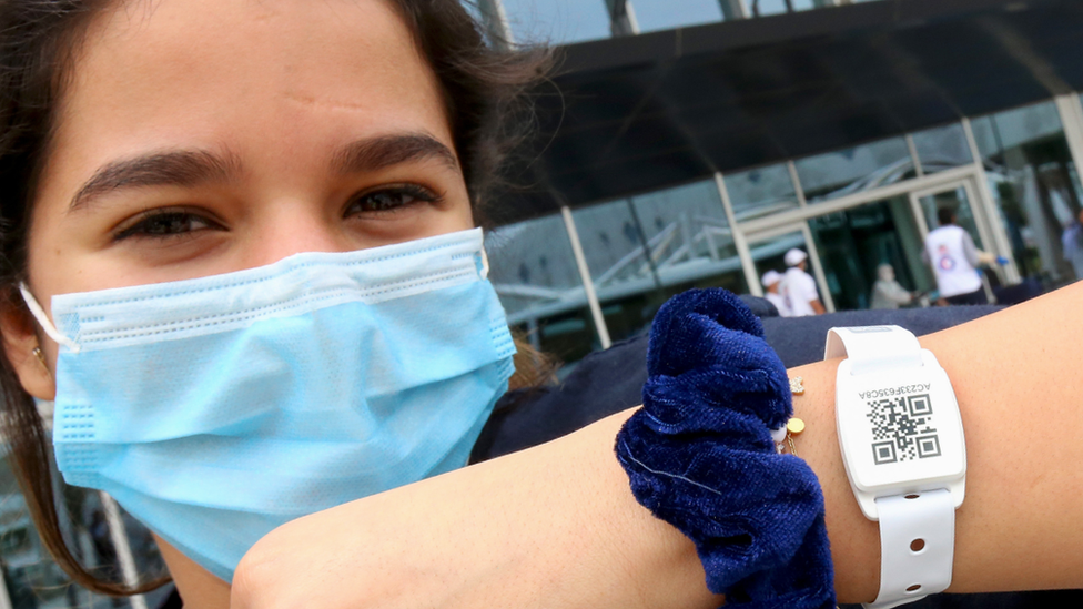 A woman wearing a tracking wristband