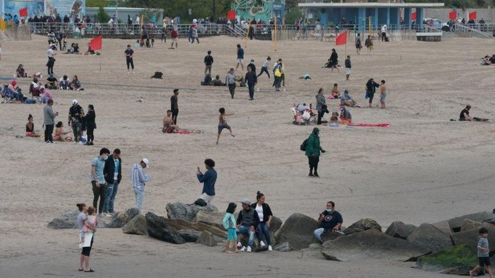 People enjoy staying on the beach as swimming is not allowed at Coney Island, New York. Photo: 24 May 2020