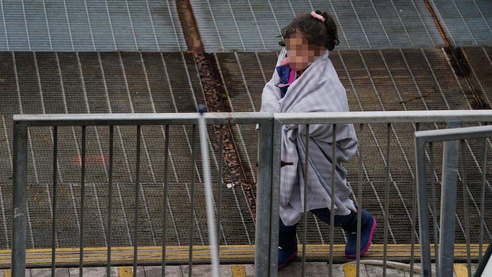 A young girl amongst a group of people thought to be migrants arrives in Dover, Kent, after being rescued by the Dover lifeboat