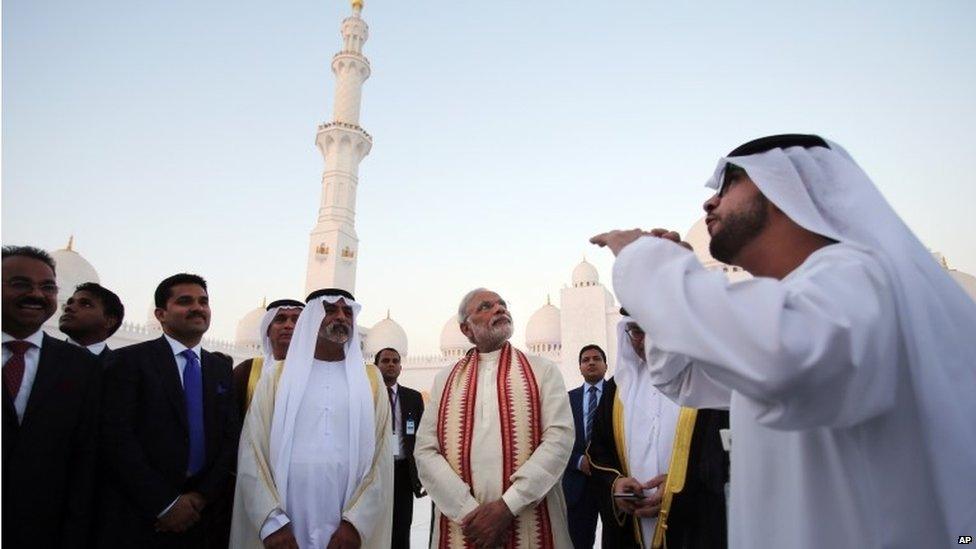 Indian Prime Minister Narendra Modi, center, listens to a guide as he visits the Sheikh Zayed Grand Mosque with Sheikh Hamdan bin Mubarak Al Nahyan, UAE Minister of Higher Education and Scientific Research, second left, during the first day of a two-day visit to the UAE, in Abu Dhabi, United Arab Emirates, Sunday, Aug. 16, 2015.