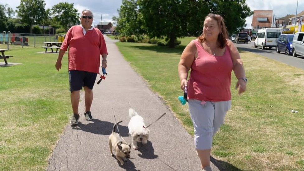 Brian and Dawn Lombardo walking their dogs