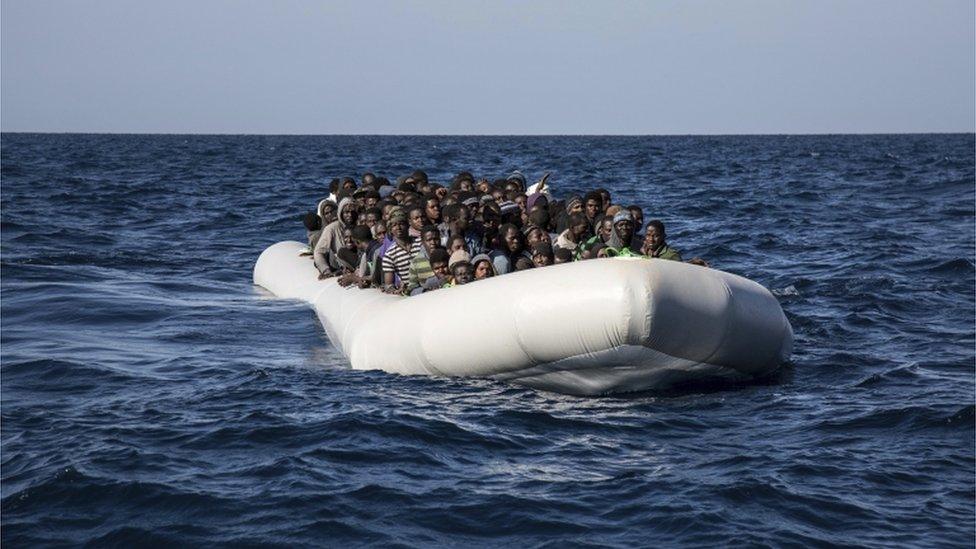 Migrants wait to board the MV Aquarius, after 193 people and two corpses were recovered Friday 13 January 2017