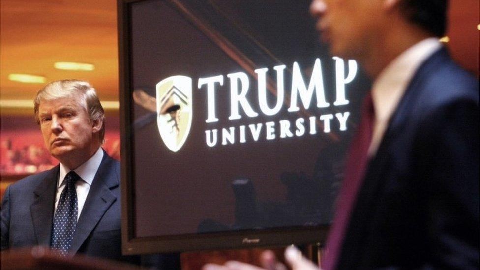 Donald Trump listens as Michael Sexton speaks at the launch of the Trump University investment school in 2005